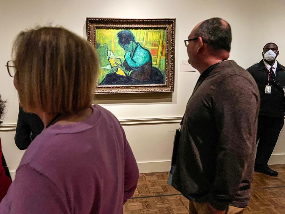 A security guard stands near the Van Gogh painting “Une Liseuse De Romans” — also known as “The Novel Reader” — at the "Van Gogh in America" exhibit at the Detroit Institute of Arts on Friday, Jan. 13, 2023. A lawsuit filed in Detroit federal court claims Brazilian art collector Gustavo Soter purchased “The Novel Reader” for $3.7 million in 2017, but lost possession of the painting.