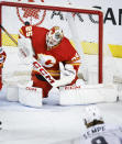 Calgary Flames goalie Jacob Markstrom (25) lets in a goal from Los Angeles Kings forward Adrian Kempe (9) during the first period of an NHL hockey game Saturday, March 30, 2024, in Calgary, Alberta. (Jeff McIntosh/The Canadian Press via AP)