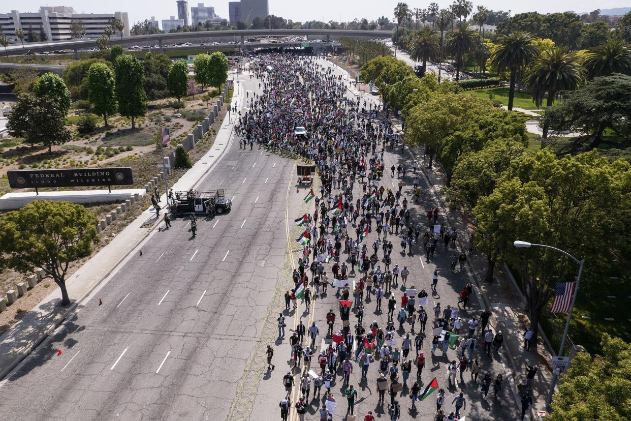 In this photo taken by a drone, thousands of demonstrators protest outside the Federal Building against Israel and in support of Palestinians during the current conflict in the Middle East on Saturday, May 15, 2021, in the Westwood section of Los Angeles.