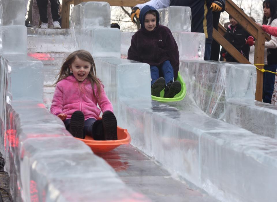 Kids ride the double-wide, 40-foot ice slide at IceFest 2023 on Saturday, Jan. 28, in downtown Chambersburg.