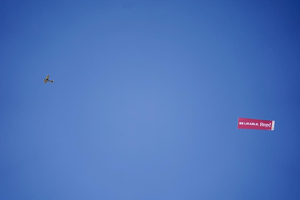 A plane flies over the Iowa State Fair pulling a banner with a message for Republican presidential candidate Florida Gov. Ron DeSantis Saturday, Aug. 12, 2023, in Des Moines, Iowa.