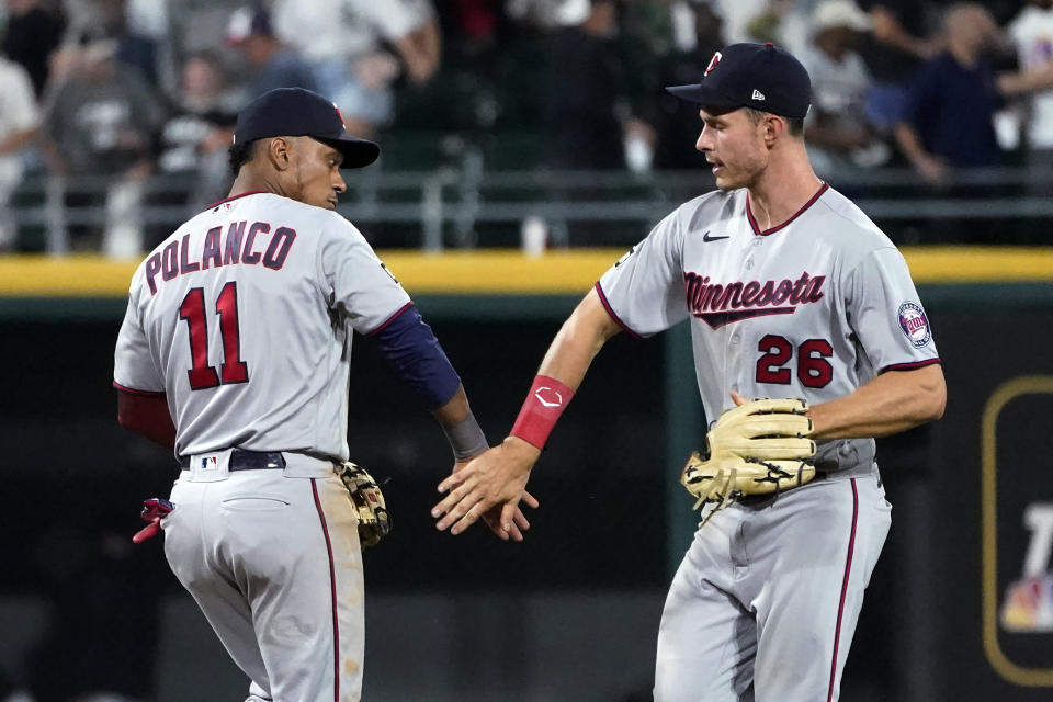 Minnesota Twins' Jorge Polanco (11) and Max Kepler celebrate the team's 7-2 win over the Chicago White Sox in a baseball game Wednesday, July 21, 2021, in Chicago. (AP Photo/Charles Rex Arbogast)