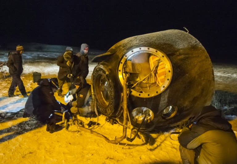 A search and rescue team works on the landing site of the Soyuz TMA-17M capsule that carried a crew from the International Space Station, near the town of Zhezkazgan, Kazakhstan on December 11, 2015