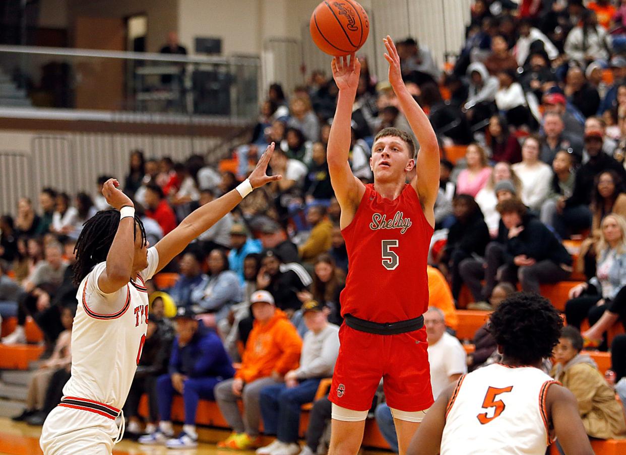 Shelby High School's Alex Bruskotter (5) puts up a shot against Mansfield Senior High School's Duke Reese, left, and Jermaine Bradley Jr (5) during high school boys basketball action Saturday, Jan. 27, 2024 at Mansfield Senior High School. TOM E. PUSKAR/MANSFIELD NEWS JOURNAL