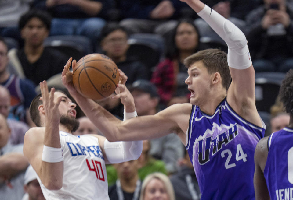 Utah Jazz center Walker Kessler (24) gets control of the ball next to Los Angeles Clippers center Ivica Zubac (40) during the first half of an NBA basketball game Friday, Dec. 8, 2023, in Salt Lake City. (AP Photo/Rick Egan)