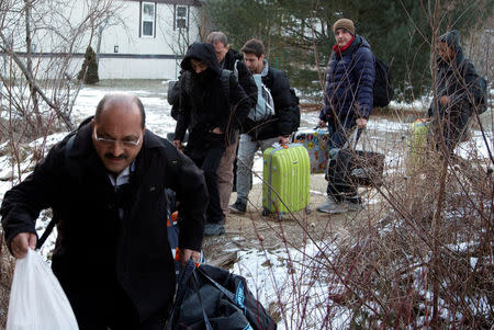 A group that claimed to be from Turkey crosses the U.S.-Canada border illegally leading into Hemmingford, Quebec, Canada March 6, 2017. REUTERS/Christinne Muschi