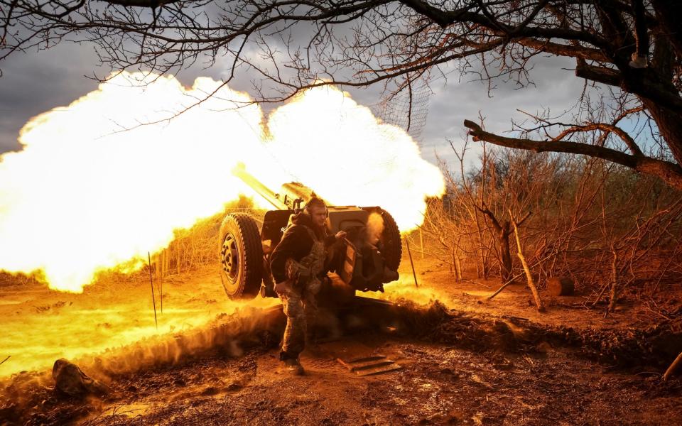 A Ukrainian service member from a 3rd separate assault brigade of the Armed Forces of Ukraine, fire a howitzer D30 at a front line, amid Russia's attack on Ukraine, near the city of Bakhmut - STRINGER/REUTERS