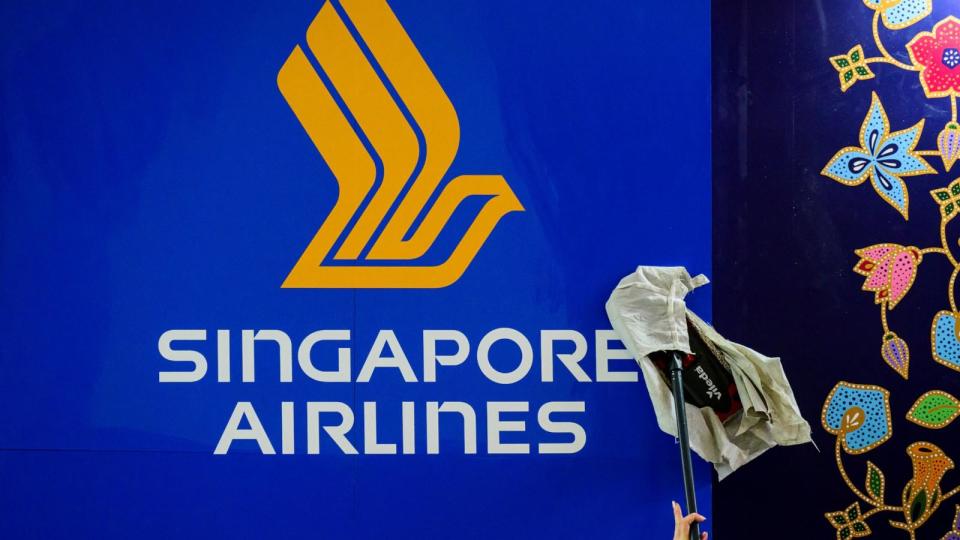 PHOTO: A worker wipes a Singapore Airlines logo at the International Tourism Trade Fair (ITB, Internationale Tourismusboerse) in Berlin on March 6, 2023.  (John Macdougall/AFP via Getty Images)