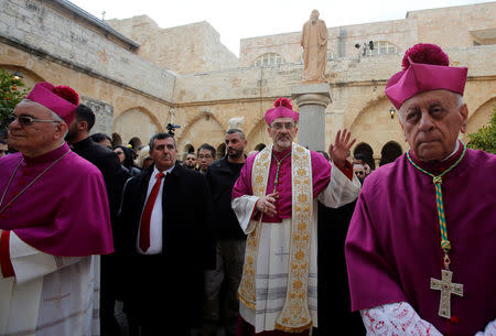 The acting Latin Patriarch of Jerusalem Pierbattista Pizzaballa waves as he arrives to attend Christmas celebrations, at the Church of the Nativity in Bethlehem, in the Israeli-occupied West Bank December 24, 2018. REUTERS/Mussa Qawasma