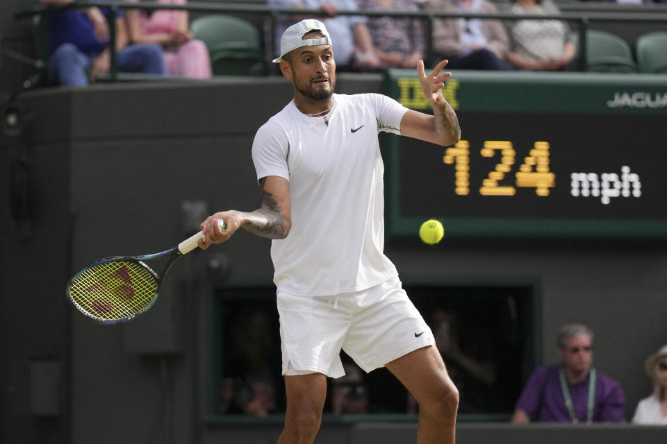 Australia's Nick Kyrgios returns the ball to Chile's Cristian Garin during a men's singles quarterfinal match on day ten of the Wimbledon tennis championships in London, Wednesday, July 6, 2022. (AP Photo/Alberto Pezzali)