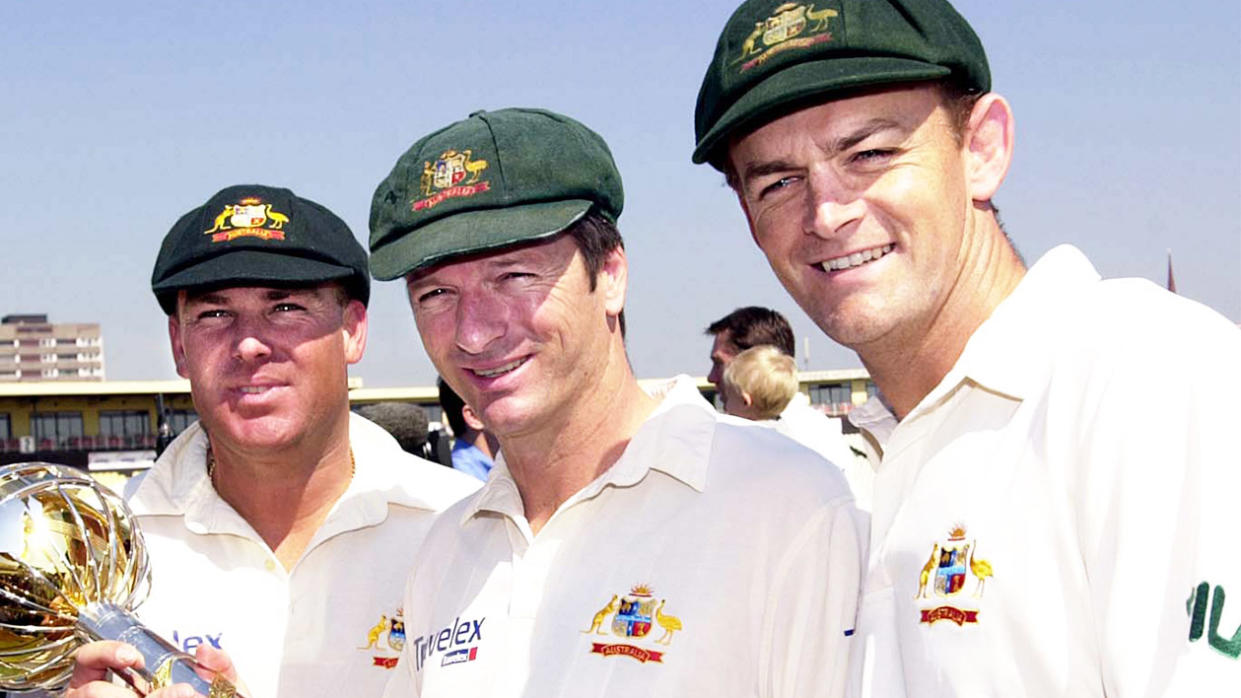 Steve Waugh (centre) smiles next to Shane Warne (left) holding the trophy and Adam Gilchrist smiling.