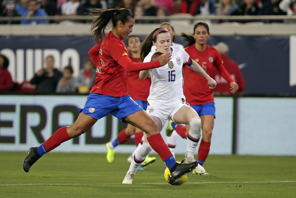 U.S. midfielder Rose Lavelle (16) moves the ball past Costa Rica defender Stephannie Blanco, left, during the first half of an international friendly soccer match Sunday, Nov. 10, 2019, in Jacksonville, Fla. (AP Photo/John Raoux)