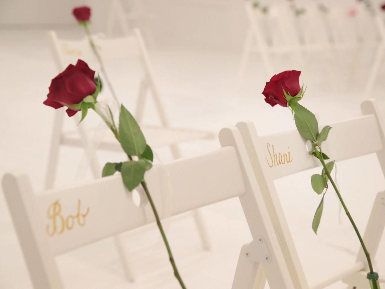 On each chair is a single rose and the name of a shooting victim: Getty Images