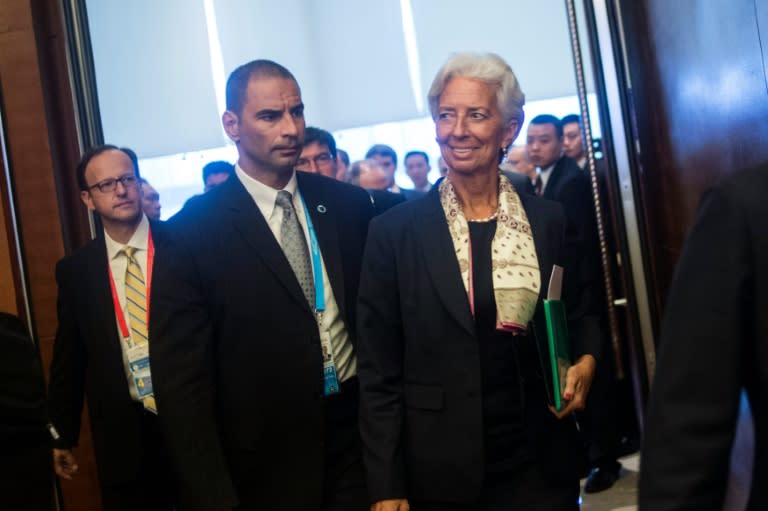 International Monetary Fund (IMF) Managing Director Christine Lagarde (R) arrives to take part in the G20 High-level Tax Symposium during a meeting of G20 finance ministers in Chengdu, in China's Sichuan province on July 23, 2016