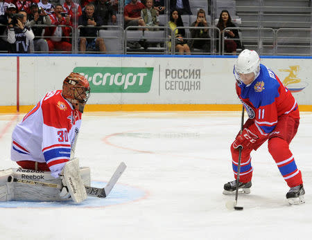 Russian President Vladimir Putin (R) takes part in a gala game of the Night Ice Hockey League in Sochi, Russia, May 10, 2016. Sputnik/Kremlin via Reuters