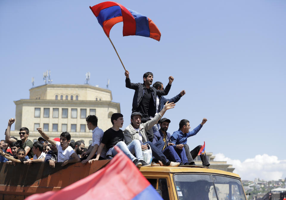 FILE - In this file photo taken on Wednesday, May 2, 2018, Supporters of opposition lawmaker Nikol Pashinian stand atop of a vehicle as they protest in Republic Square in Yerevan, Armenia. Armenians are set to cast ballots in parliamentary elections expected to cement the incumbent prime minister's grip on power. (AP Photo/Sergei Grits, File)