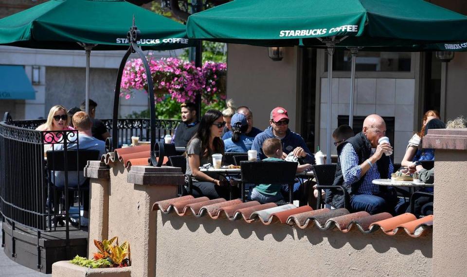 Customers at Starbucks on the Country Club Plaza could shed their masks as Mayor Quinton Lucas announced Friday the city is fully lifting its COVID-19 emergency order.