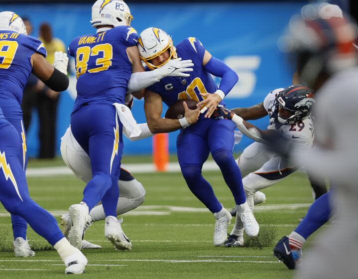 Chargers quarterback Justin Herbert is sacked by Broncos outside linebacker Nik Bonitto.