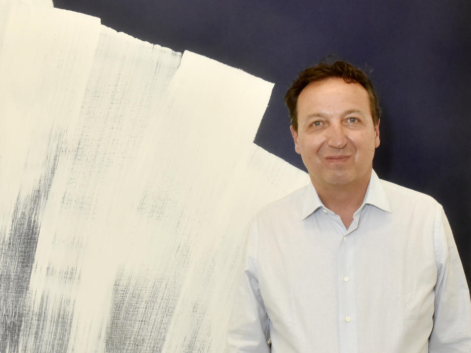 PARIS, FRANCE - JUNE 12: Gallerist Emmanuel Perrotin poses with A work of Hans Hartung during "Hartung 80 " Press Preview at Galerie Perrotin on June 12, 2021 in Paris, France. (Photo by Foc Kan/WireImage)