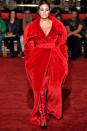 <p>For her first walk down the runway of the season, the model wore a belted fluffy red coat, with nothing but thigh-high boots underneath. (Photo: Getty Images) </p>