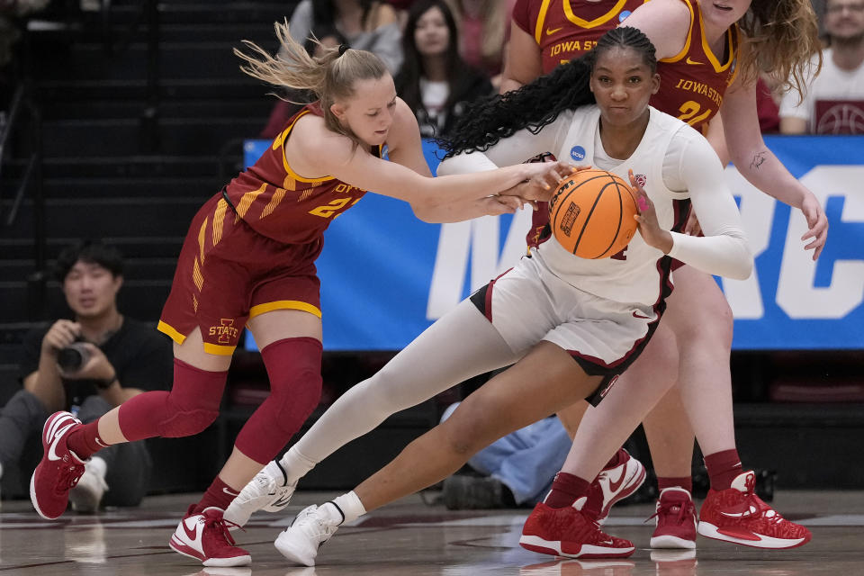 Iowa State guard Kelsey Joens, left, reaches for the ball against Stanford forward Kiki Iriafen during the first half of a second-round college basketball game in the women's NCAA Tournament in Stanford, Calif., Sunday, March 24, 2024. (AP Photo/Jeff Chiu)