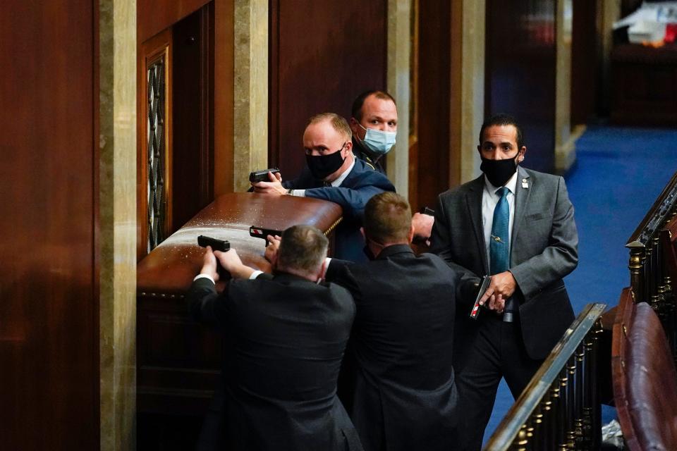 Capitol police guard a barricaded door as protesters try to break into the House chamber at the U.S. Capitol on Jan. 6.