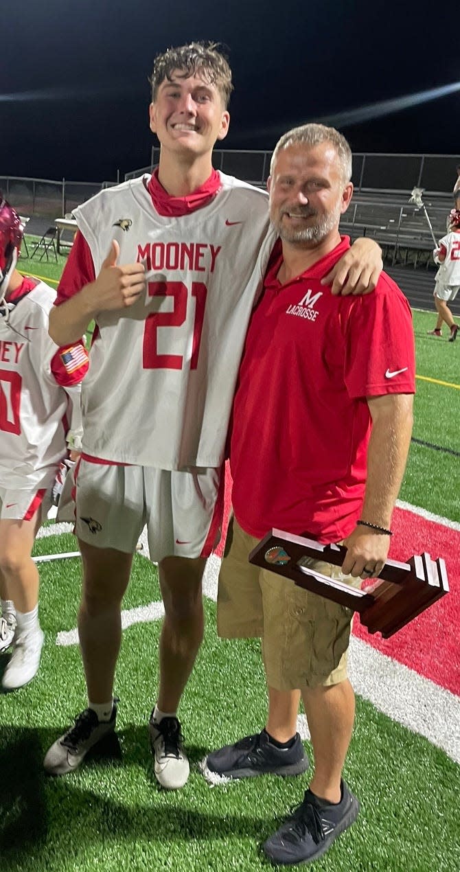 Cardinal Mooney senior lacrosse player Carter Westendorf stands with head coach Derek Wagner after the Cougars' loss on Saturday to the Community School of Naples in the Class A-Region 3 championship.