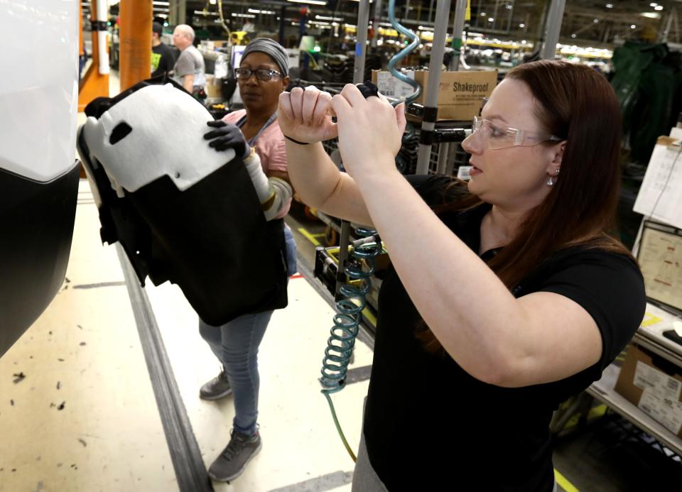 Corinne Peltier, who runs the WorkFit program, gives advice about lifting parts with Dianne Henderson, 66, a line worker at the General Motors Lansing Delta Township Assembly Plant in Delta Township, Michigan on Thursday, January 16, 2020.