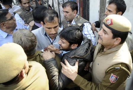 Kanhaiya Kumar (bottom, 2nd R), head of the student's union at Delhi's Jawaharlal Nehru University (JNU), is escorted by police outside the Patiala House court in New Delhi, India February 17, 2016. REUTERS/Stringer