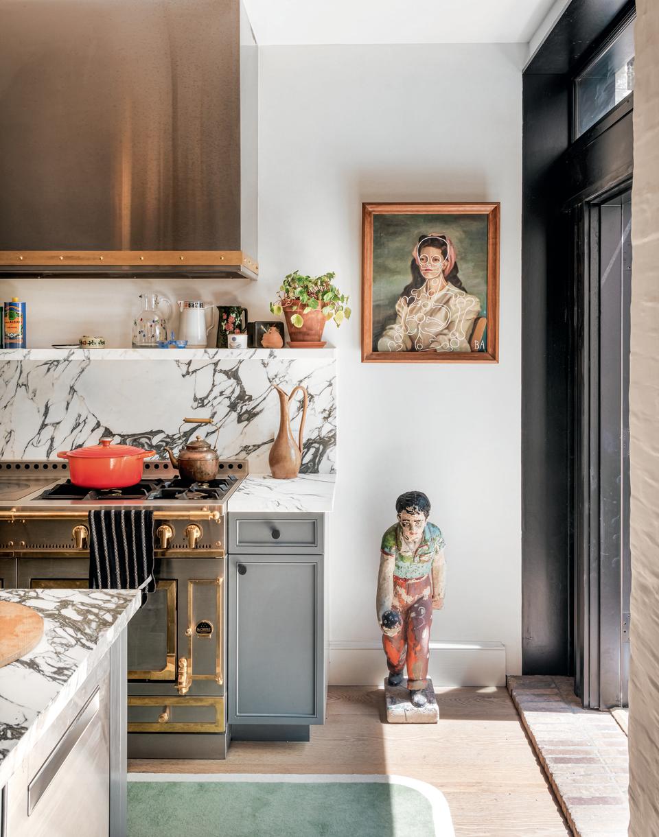 A kitchen with an artwork on the walls