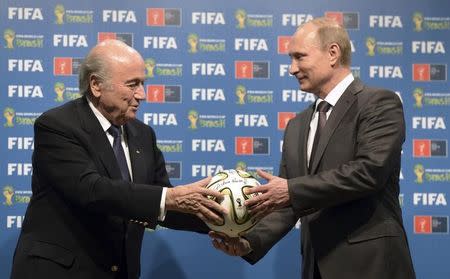 Russia's President Vladimir Putin (R) and FIFA President Sepp Blatter take part in the official hand over ceremony for the 2018 World Cup scheduled to take place in Russia, in Rio de Janeiro July 13, 2014. REUTERS/Alexey Nikolsky/RIA Novosti/Kremlin