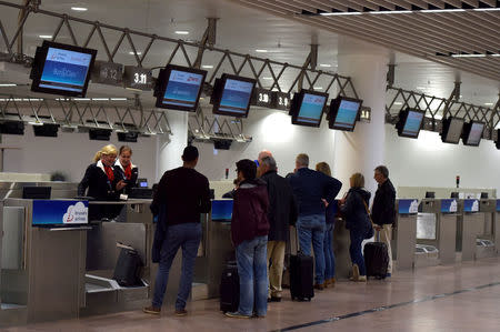 Travellers check in in the departure hall after a ceremony at Brussels Airport as it reopens 40 days after deadly attacks in Zaventem, Belgium, May 1, 2016. REUTERS/Eric Vidal