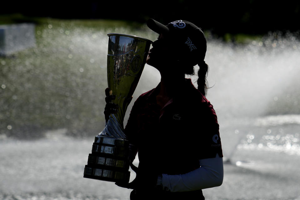 France's Celine Boutier kisses her trophy after winning the Evian Championship women's golf tournament in Evian, eastern France, Sunday, July 30, 2023. (AP Photo/Lewis Joly)