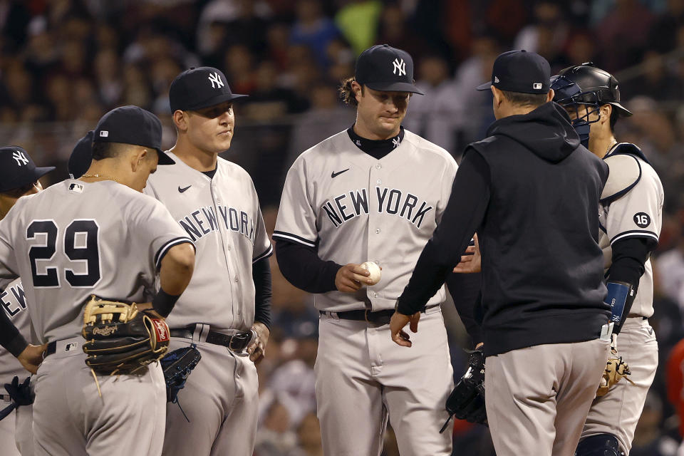 BOSTON, MASSACHUSETTS - OCTOBER 05: Manager Aaron Boone #17 takes out Gerrit Cole #45 of the New York Yankees against the Boston Red Sox during the third inning of the American League Wild Card game at Fenway Park on October 05, 2021 in Boston, Massachusetts. (Photo by Winslow Townson/Getty Images)