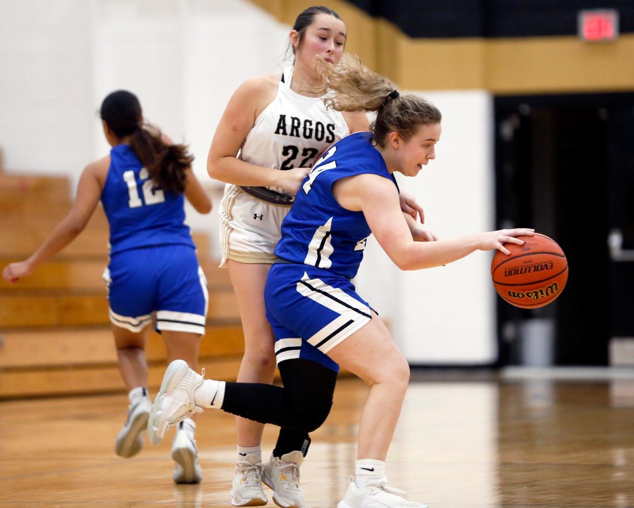 Bethany Christian senior Mariah Stoltzfus looks to dribble around Argos junior Morgyn Barcus during a girls basketball game Thursday, Dec. 21, 2023, at Argos High School.