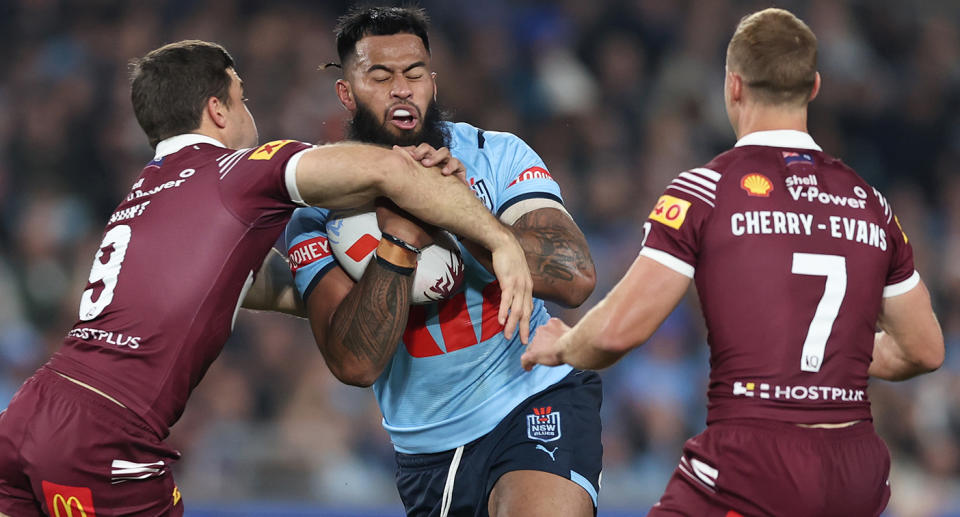 Seen here, NSW prop Payne Haas is tackled by Maroons hooker Ben Hunt in Game 1 of the State of Origin series. 