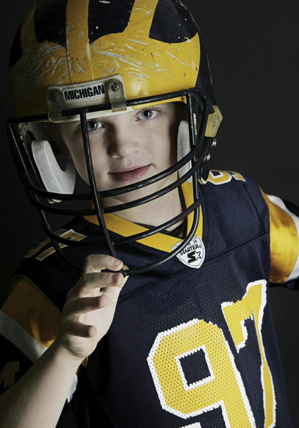 In a photo provided by Melissa Hutchinson, Aidan Hutchinson wears a Michigan football helmet, date and location not known. Jacksonville is expected to select Hutchinson with the No. 1 pick in the NFL draft on Thursday night, April 28. It's easy to see why the Jaguars would want him after watching what Hutchinson did last year at Michigan. Scouts who searched for more about his background found out Chris and Melissa raised a well-rounded son, uniquely shaped by a close-knit family that includes two older sisters. (Melissa Hutchinson via AP)