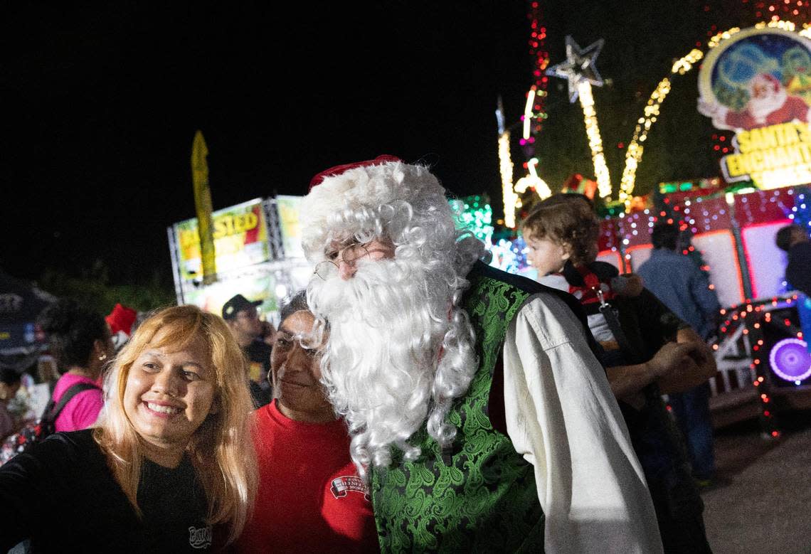 Astrid Martinez and a friend take a selfie with Santa during the opening night of Santa’s Enchanted Forest.