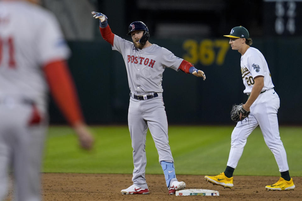 Boston Red Sox's Trevor Story, center, reacts after hitting an two-run double against the Oakland Athletics during the third inning of a baseball game Monday, April 1, 2024, in Oakland, Calif. (AP Photo/Godofredo A. Vásquez)