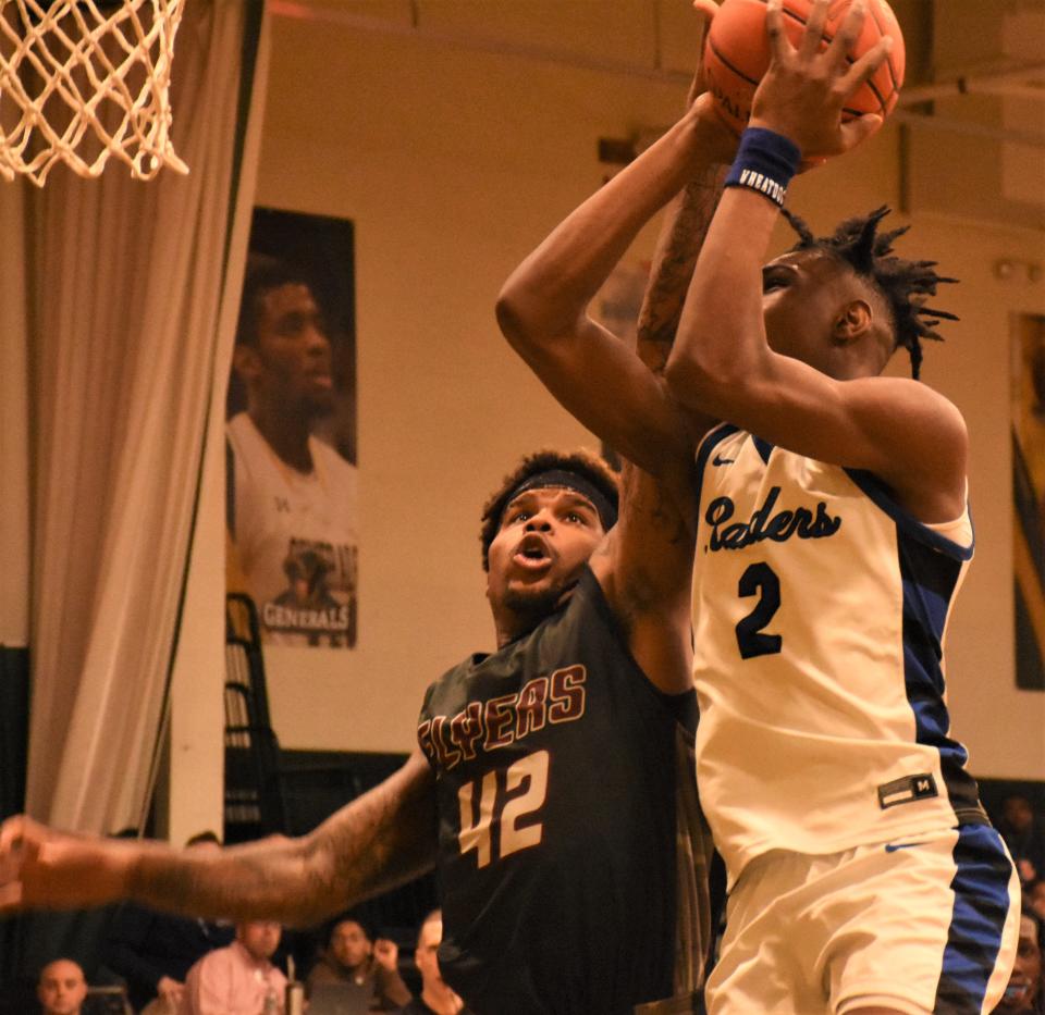 Sandhills Community College freshman Damien Robinson (42) defends against a shot by Fulton-Montgomery Community College Raider Nahjhime Kirton during an NJCAA tournament game in Herkimer Wednesday.