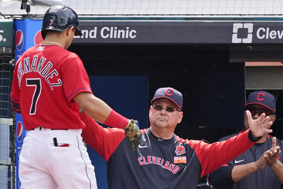 Cleveland Indians manager Terry Francona, right, congratulates Cesar Hernandez after Hernandez hit a solo home run in the third inning of the first baseball game of a doubleheader against the Chicago White Sox, Monday, May 31, 2021, in Cleveland. (AP Photo/Tony Dejak)