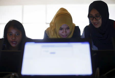 Indonesian youths fill up job application forms on laptops provided by organizers at the Indonesia Techno Career in Jakarta, June 11, 2015. REUTERS/Beawiharta