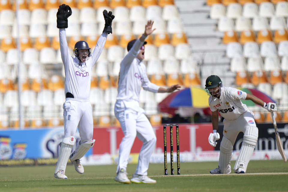 England's Jamie Smith, left, and Ollie Pope, center, appeal for LBW out of Pakistan's Salman Ali Agha during the fifth day of the first test cricket match between Pakistan and England, in Multan, Pakistan, Friday, Oct. 11, 2024. (AP Photo/Anjum Naveed)