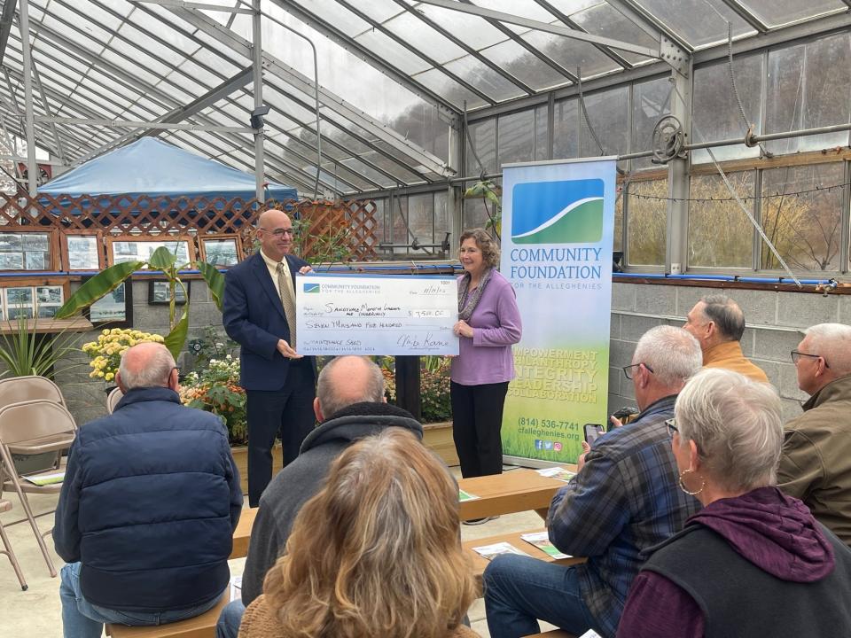 Mike Kane, left, president and executive director of the Community Foundation for the Alleghenies, presents a $7,500 grant on Nov. 21 to Diana Kabo, president of the Sandyvale Memorial Gardens and Conservancy in Johnstown. Sandyvale was one of 87 projects in a four-county region, including Somerset, to be awarded grant funding during the foundation's 2023 fall grant distribution.