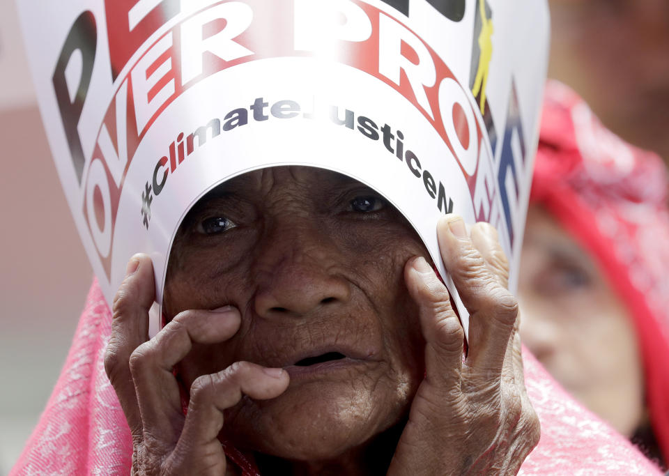 An environmental activist holds a placard during a rally outside the Department of Environment and Natural Resources to coincide with the global protests on climate change Friday, Sept. 20, 2019 at suburban Quezon city, northeast of Manila, Philippines. Various environmental groups in the country are participating in what is expected to be the world's largest mobilization on climate change known as "Global Climate Strike." (AP Photo/Bullit Marquez)