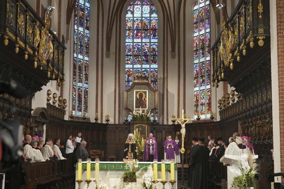 The head of Poland's Roman Catholic Church, Archbp Stanislaw Gadecki, right, and Archbishop Sviatoslav Shevchuk, left, of the Ukrainian Greek Catholic Church hold a reconciliation religious service as part of observances honoring some 100,000 Poles murdered by Ukrainian nationalists in 1943-44, at St. John's cathedral in Warsaw, Poland, on Friday, July 7, 2023. (AP Photo/Czarek Sokolowski)