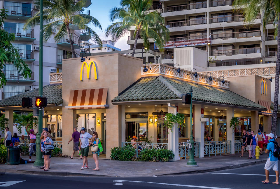 a mcdonald's store front surrounded by palm trees