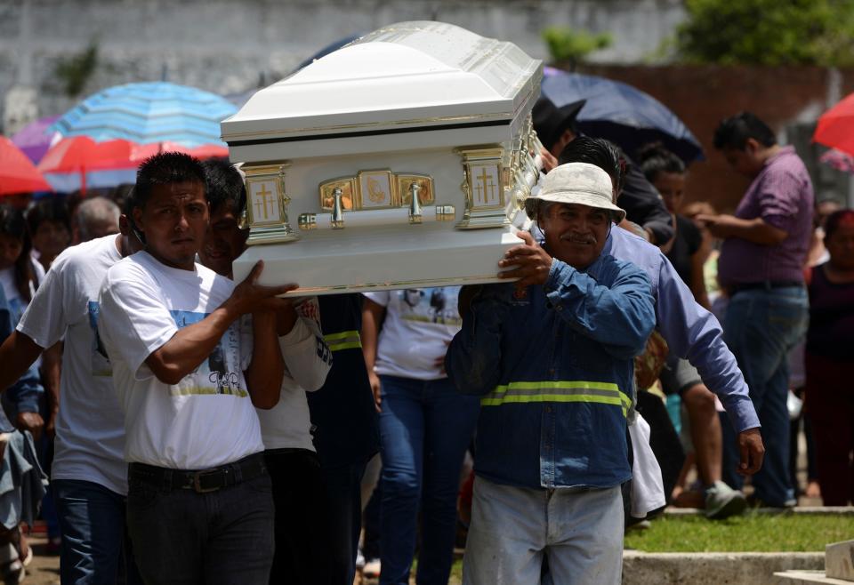 <p>Relatives and friends of Joel Rayon Paniagua, one of the victims of the shooting at the Pulse night club in Orlando, carry his coffin while arriving to a cemetery for his funeral in Cordoba, in Veracruz state, Mexico, June 24, 2016. (REUTERS/Oscar Martinez) </p>