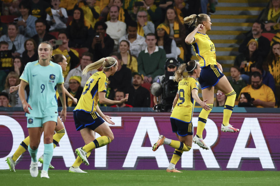 Sweden's Fridolina Rolfo, right, celebrates after scoring her team's first goal from the penalty spot during the Women's World Cup third place playoff soccer match between Australia and Sweden in Brisbane, Australia, Saturday, Aug. 19, 2023. (AP Photo/Tertius Pickard)