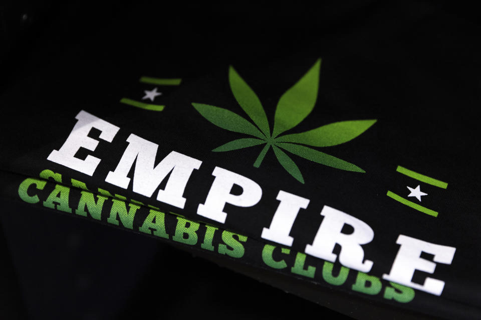 Empire Cannabis Club shirts sit on display at the shop, Wednesday, Nov. 16, 2022, in New York. Under pressure to launch one of the nation’s most hotly anticipated legal marijuana markets, the state Cannabis Control Board is set Monday to consider awarding some dispensary licenses to entrepreneurs and nonprofit groups — a major step that comes as cannabis regulators stress that they're trying to stop unlicensed sellers. (AP Photo/Julia Nikhinson)